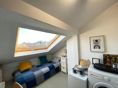 a small bedroom with a bed and a window at LK17 - Loft in the Center in Sofia