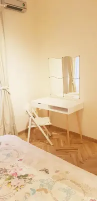 a dressing table with a mirror and a chair in a room at Graf Ignatiev Central Apartment in Sofia
