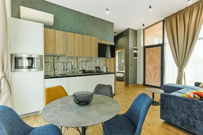 a kitchen and living room with a table and chairs at Terme di Hissar Village in Hisarya