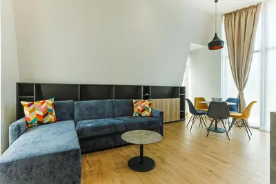 a living room with a blue couch and a table at Terme di Hissar Village in Hisarya