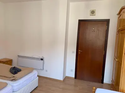 a room with a door and a couch and a wooden door at Flora Clover One Bedroom Apartment nr. 18 in Borovets