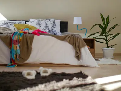 a bedroom with a bed with a blanket on it at Altavista mountain apartment in Samokov