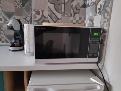 a microwave sitting on top of a counter at Altavista mountain apartment in Samokov