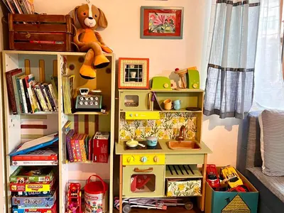 a toy shelf with toys on top of it at Къща за гости ЗЕЛЕНА in Vinogradets