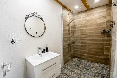 a bathroom with a toilet and a sink and a shower at Къща за гости ЗЕЛЕНА in Vinogradets