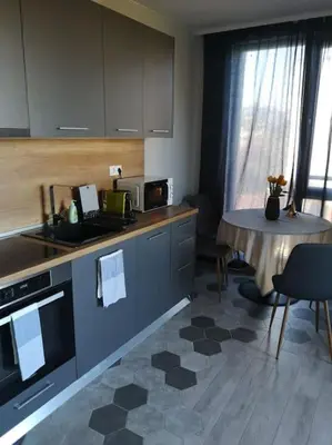 a kitchen with a table and a counter top at Apartment Opalchenska / Pirotska in Sofia
