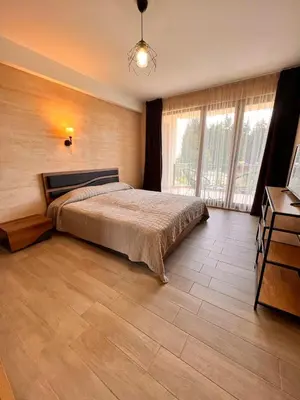 a bedroom with a bed and a large window at Boutique Villas Murgavets Pamporovo in Pamporovo