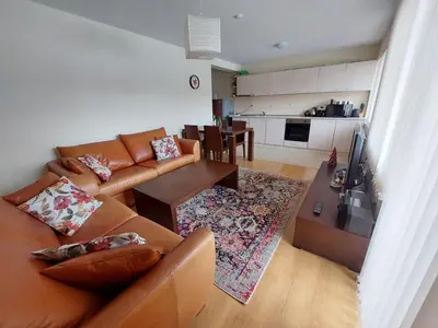 a living room with a couch and a table at Apartment Pirin in Bansko
