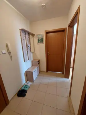 a hallway of a room with a door and a tile floor at Apartment Pirin in Bansko