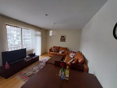 a living room with a couch and a table at Apartment Pirin in Bansko