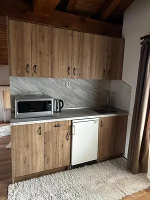 a kitchen with a microwave on top of a counter at Snow House in Bansko