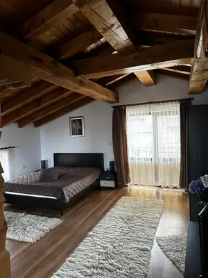 a bedroom with a bed and a large window at Snow House in Bansko