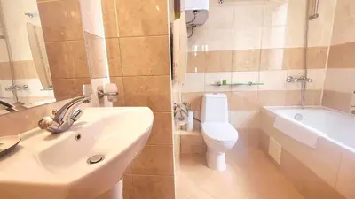 a bathroom with a sink and a toilet and a tub at Arboro Flora Residence Studio in Borovets