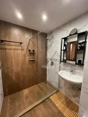 a bathroom with a shower and a sink and a sink at Апартамент - Боровец Хотел ''Боровец Гардънс'' A 44 in Borovets