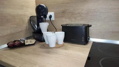 a counter with a toaster and cups next to a toaster at Arboro Borovets Gardens E50 in Borovets