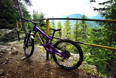 a purple bike parked next to a rail at Arboro Borovets Gardens E68 in Borovets