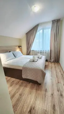 a bedroom with a large bed and a large window at Arboro Borovets Gardens E68 in Borovets