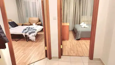 a room with a mirror and a room with a bed at Arboro Royal Plaza in Borovets