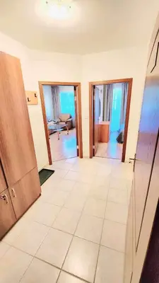 a living room with a large tile floor and sliding doors at Arboro Royal Plaza in Borovets