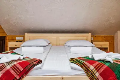two beds sitting next to each other in a room at Sofia Folklore Life Apartment in Sofia