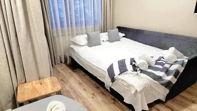 a bedroom with a bed with white sheets and pillows at Arboro Borovets Gardens E43 in Borovets