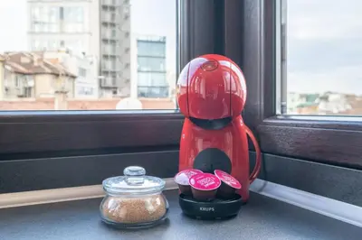 a red blender sitting on a window sill next to a jar at Budget Stay in City Center near NDK in Sofia