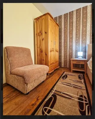a living room with a couch and a table at Къща за гости Карасански in Bansko