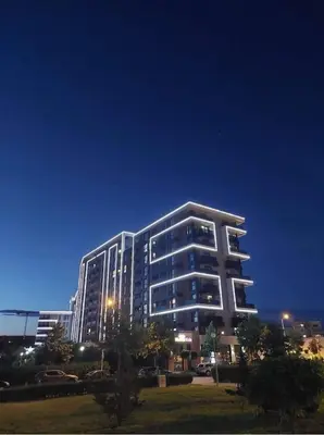 a large building at night with the lights on at City Park Inn Apartment Cortona in Plovdiv