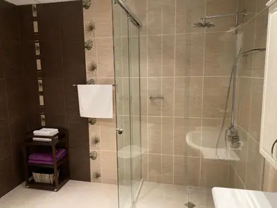 a bathroom with a shower with a glass door at Sana Ski apartment 620 in Flora, Borovets in Borovets