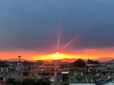 a sunset over a city with houses and buildings at Amazing view central 1 bedroom apartment in Pazardzhik
