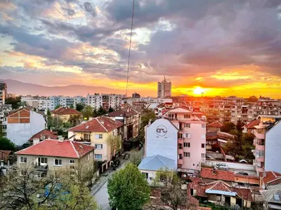 a view of a city at sunset with buildings at Amazing view central 1 bedroom apartment in Pazardzhik