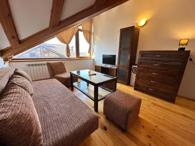 a living room with a couch and a table at Snow Legend private apartments in Bansko