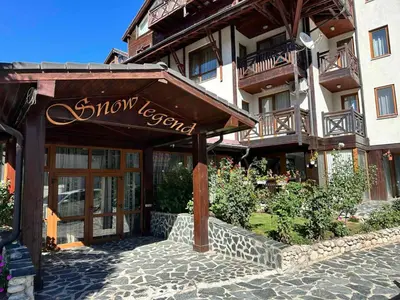 a sign for a showroom in front of a building at Snow Legend private apartments in Bansko