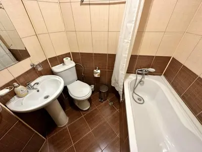 a bathroom with a toilet and a sink and a tub at Snow Legend private apartments in Bansko