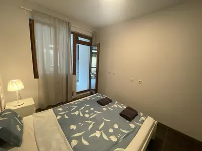 a bedroom with a bed and a window at Top Center 2-BR Apartment with lovely Outdoor Area in Plovdiv