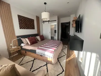 a bedroom with a bed and a television in it at Ski Bansko Design Apartments in Bansko