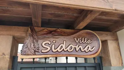 a sign for aiya subaru on top of a building at Къща за гости - Вила Сидона in Banya