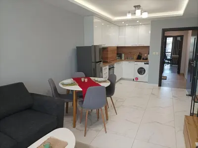 a living room with a table and chairs and a kitchen at One Bedroom Apartment 37- Trakia 54 А in Plovdiv