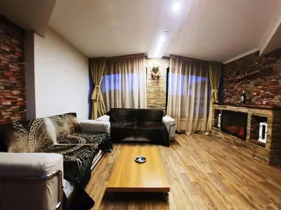 a living room with a couch and a fireplace at Boutique & artistic 3 bedroom apartment. in Pamporovo