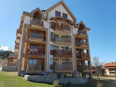 a tall building with balconies on the side of it at Secluded Mountain Cozy Studio with Fireplace in Bansko