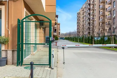 a gate on the side of a street with buildings at Bright & Cozy 1BD Flat with a Terrace and Parking by Flat Mаnager in Plovdiv