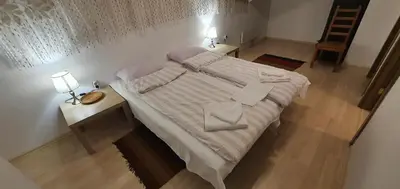 a bedroom with a large bed with two night stands and two lamps at Penthouse Harriet Bansko in Bansko