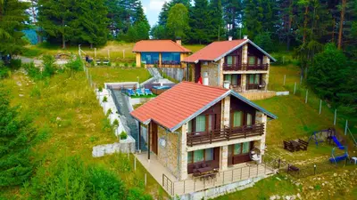 an aerial view of a house with a red roof at Къщи за гости Фантазия in Dospat