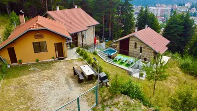 an aerial view of a house on a hill at Къщи за гости Фантазия in Dospat
