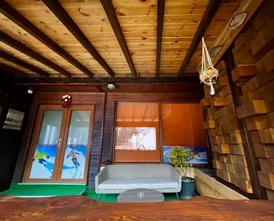 a living room with a couch and a window at Roots Apartment 2 in Borovets