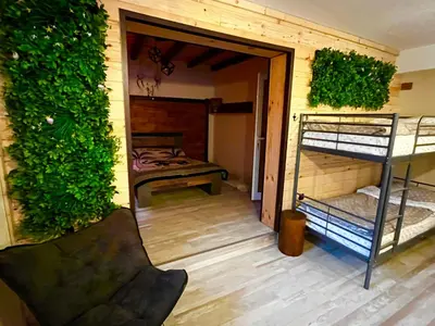 a room with a bedroom and a bunk bed at Roots Apartment 2 in Borovets