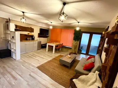 a living room with a couch and a table at Roots Apartment 2 in Borovets