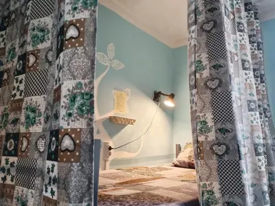 a room with a bed and a curtain in a room at 