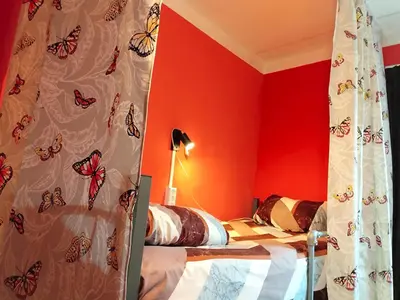 a bedroom with a bed with butterflies on the curtains at 