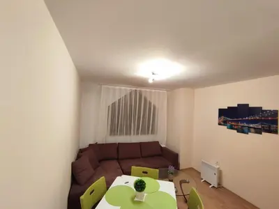 a living room with a couch and a table at Pirin Sunrise in Bansko